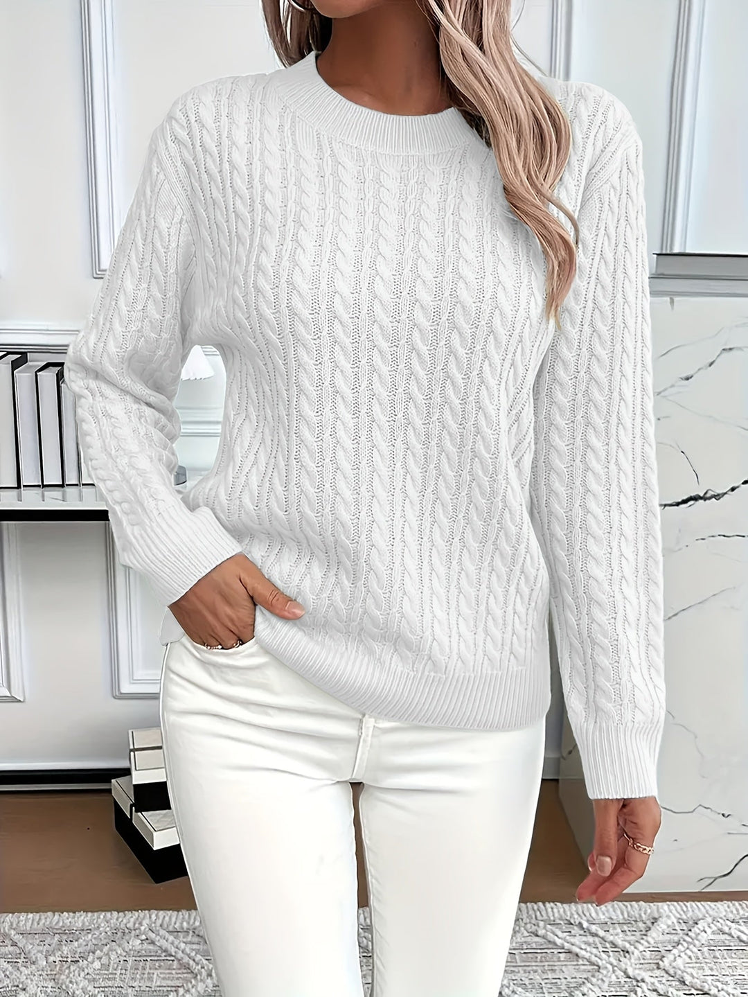 Close-up of a women's cable knit sweater showcasing its intricate texture and soft yarn.