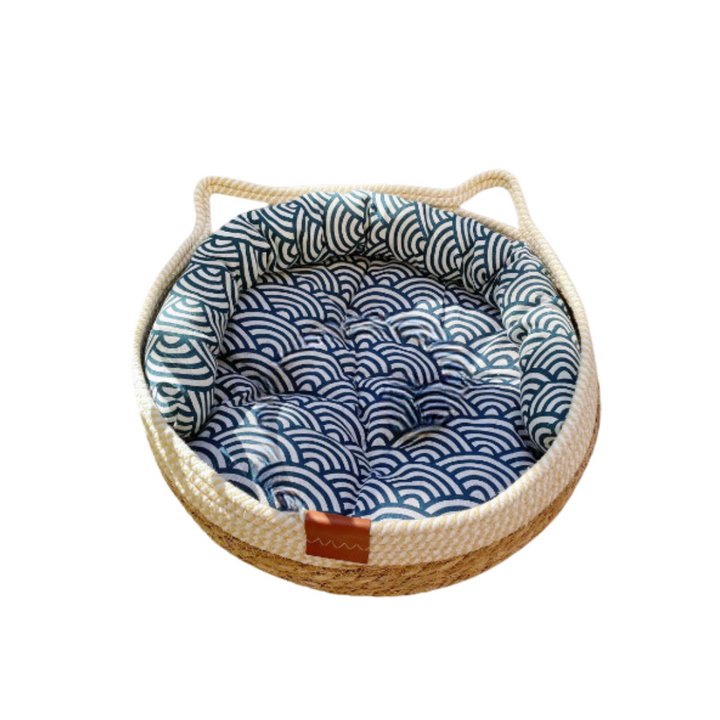 Stylish and functional cat furniture: a comfortable bed with a built-in sisal scratching ball.