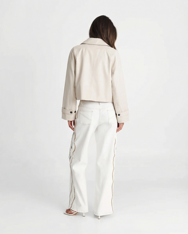 Modern cream cropped jacket for women, short and relaxed fit, embodying effortless minimalist style.