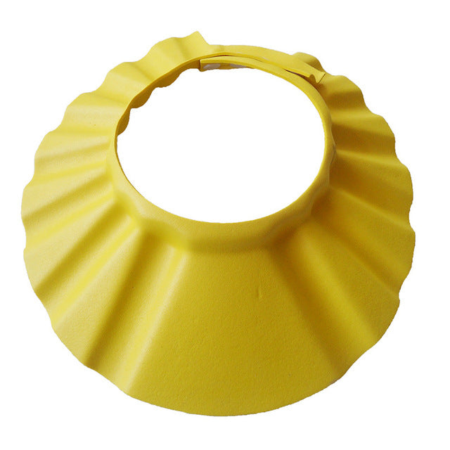 Cute baby wearing adjustable EVA shampoo hat for safe bath time, protecting eyes and ears.