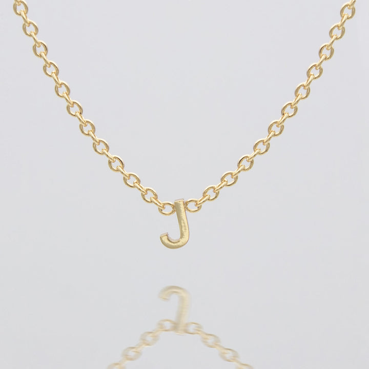 Women's personalized gold dainty initial necklace.