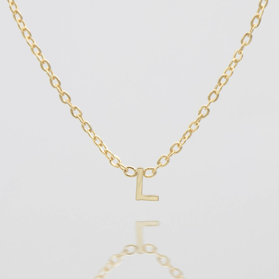 Personalized silver initial necklace, minimalist design.