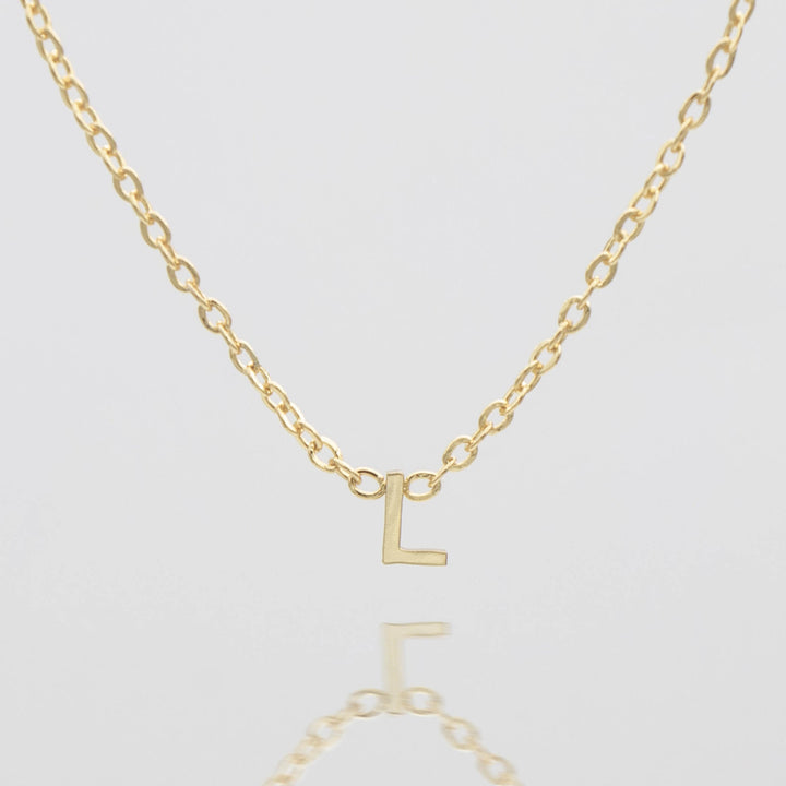 Personalized silver initial necklace, minimalist design.