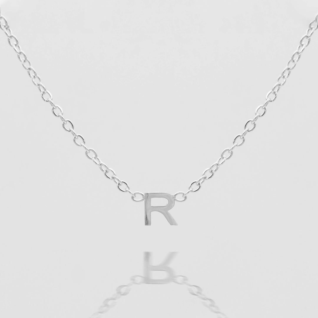 Women's personalized silver initial necklace, minimalist style.