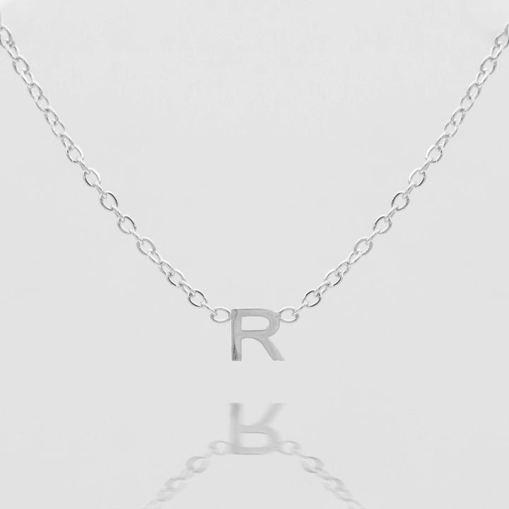 Women's personalized silver initial necklace, minimalist style.