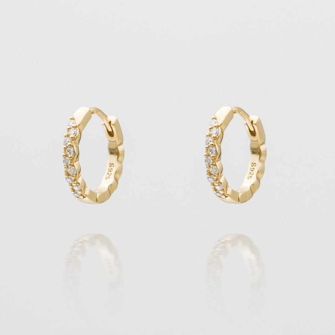 Dainty women's gold plated huggie hoop earrings, perfect for everyday wear. Elegant jewelry gift.
