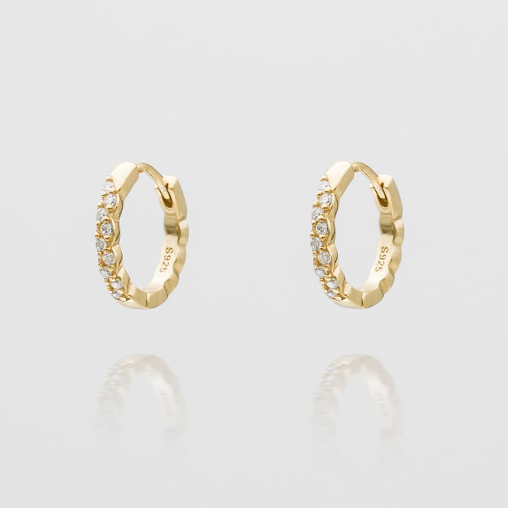 Dainty women's gold plated huggie hoop earrings, perfect for everyday wear. Elegant jewelry gift.