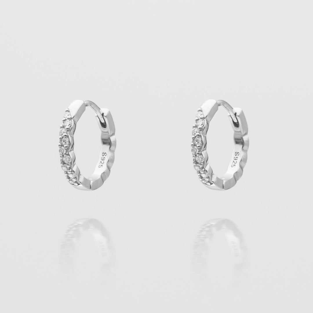 Shiny silver plated huggie hoop earrings for women, a minimalist and chic jewelry accessory.