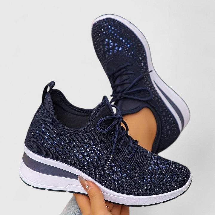 Close-up of the sparkling rhinestones & breathable mesh texture on women's dazzling wedge sneakers.
