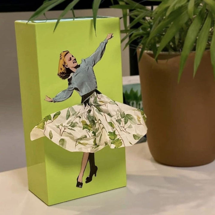 Vintage-inspired flying skirt design tissue box holder. Artistic home accessory for desks, living rooms.