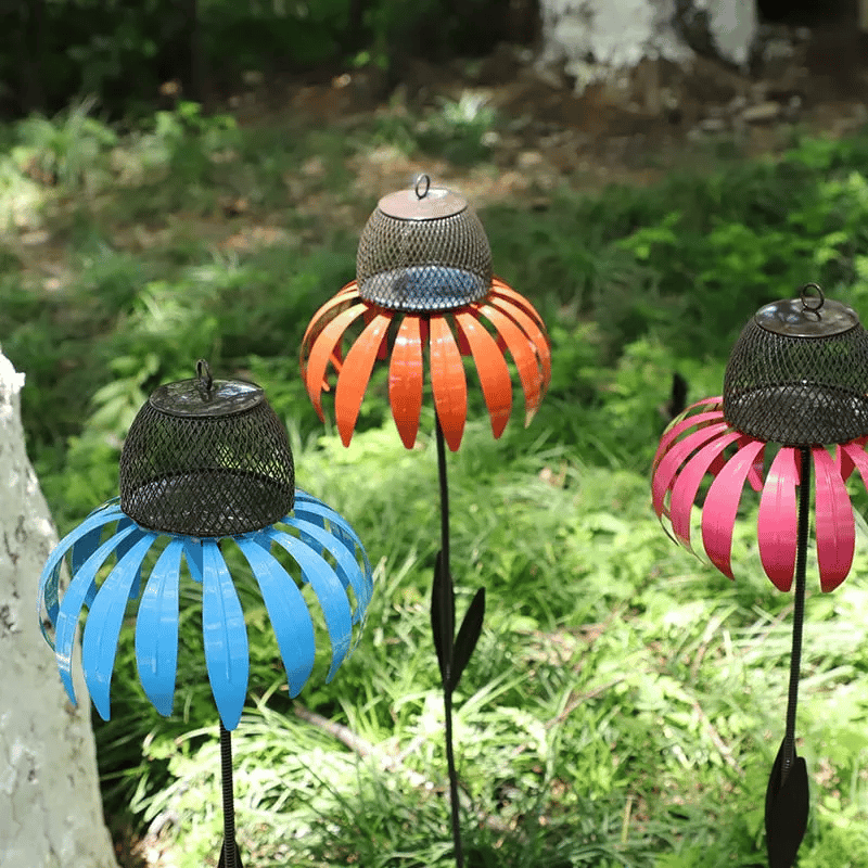 Orange metal flower bird feeder, a durable and decorative garden ornament.