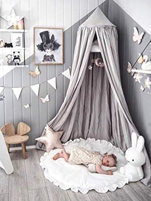 Enchanting magical kids' bed canopy transforms a nursery into a whimsical play tent or a dreamy, cozy reading nook.