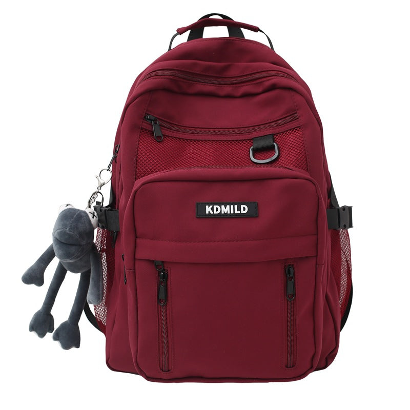 Close-up of durable fabric and multiple compartments on a reliable unisex travel school commuter backpack.