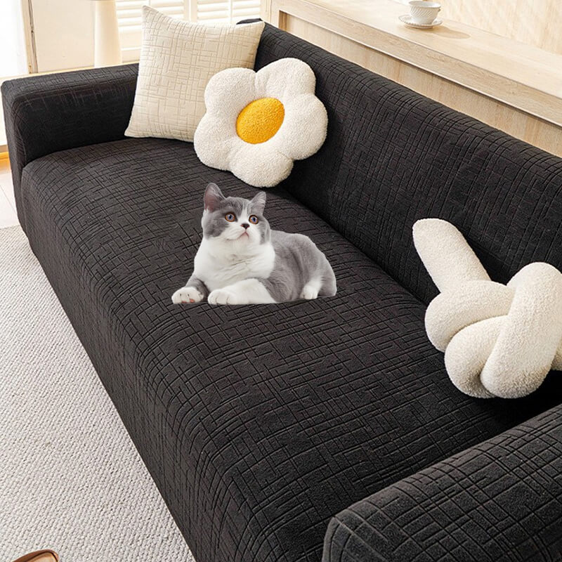 Happy dog lounging on a pet-friendly jacquard sofa slipcover, offering anti-scratch protection.
