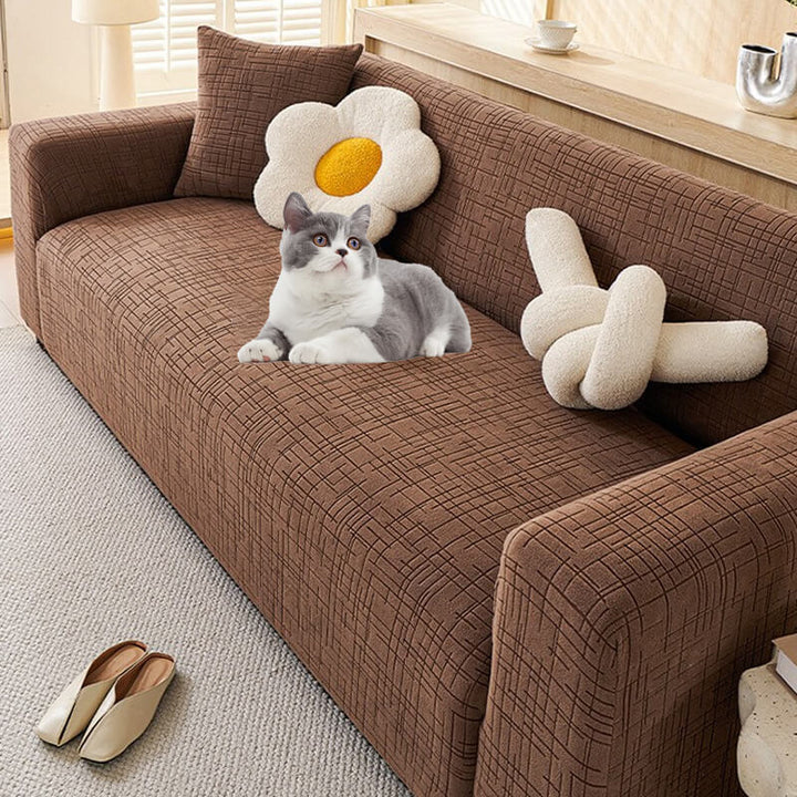 Elastic jacquard couch cover stretching to fit a sofa perfectly, ensuring a snug & durable fit.