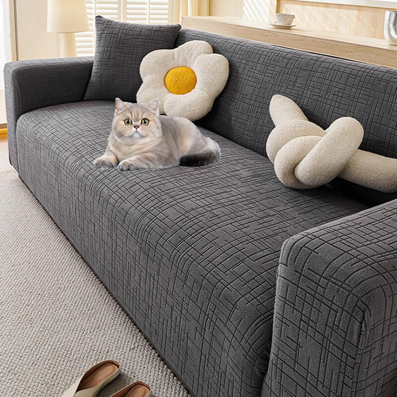Stylish blue jacquard pet sofa cover, a durable and stretch-fit furniture protector for pets.