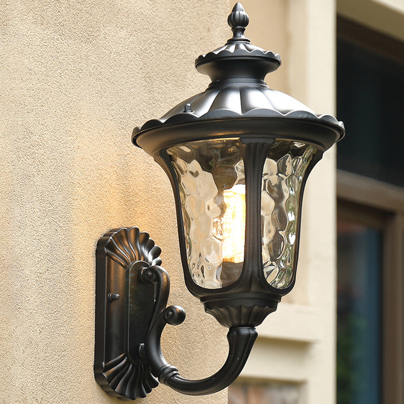 Bronze exterior wall sconce, weatherproof for elegant outdoor home lighting.