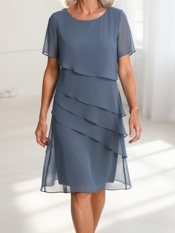 Front view of the Elarisse midi dress, highlighting its flattering cut and ruffle hem.