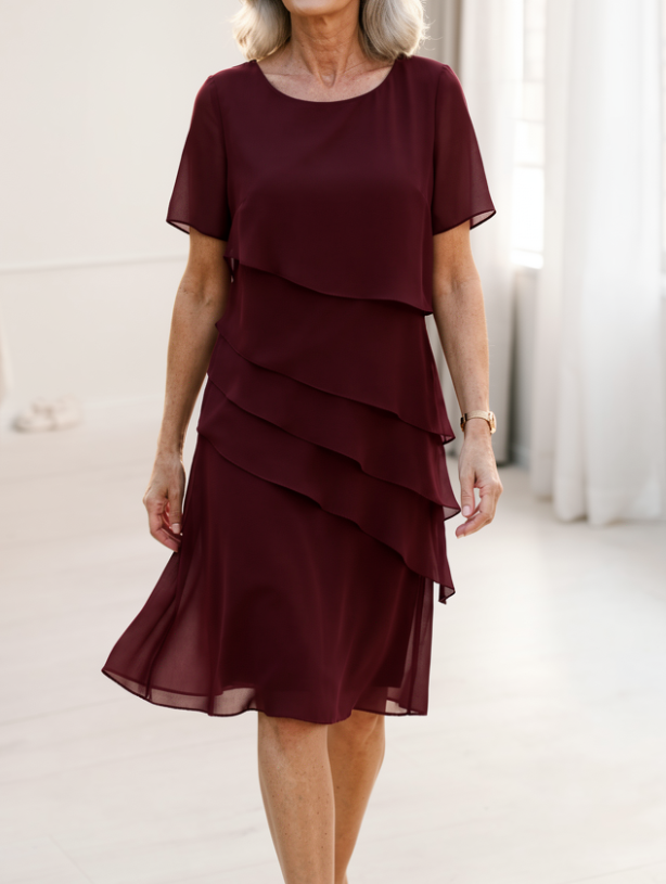 Side profile of the Elarisse elegant ruffle dress, emphasizing its graceful flow.