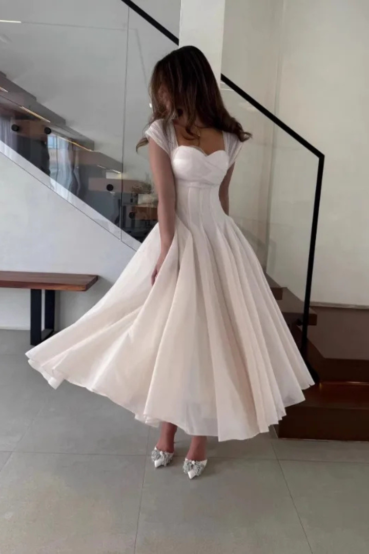 Stylish women's elegant midi dress, perfect for wedding guests or special occasion parties. Sweetheart & cap sleeves.