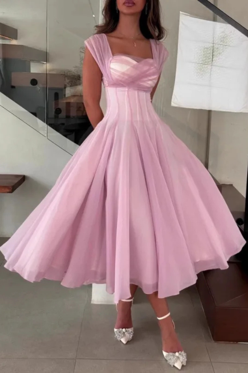 Chic apricot pink midi wedding guest dress. Elegant A-line silhouette with sweetheart neckline & cap sleeves.