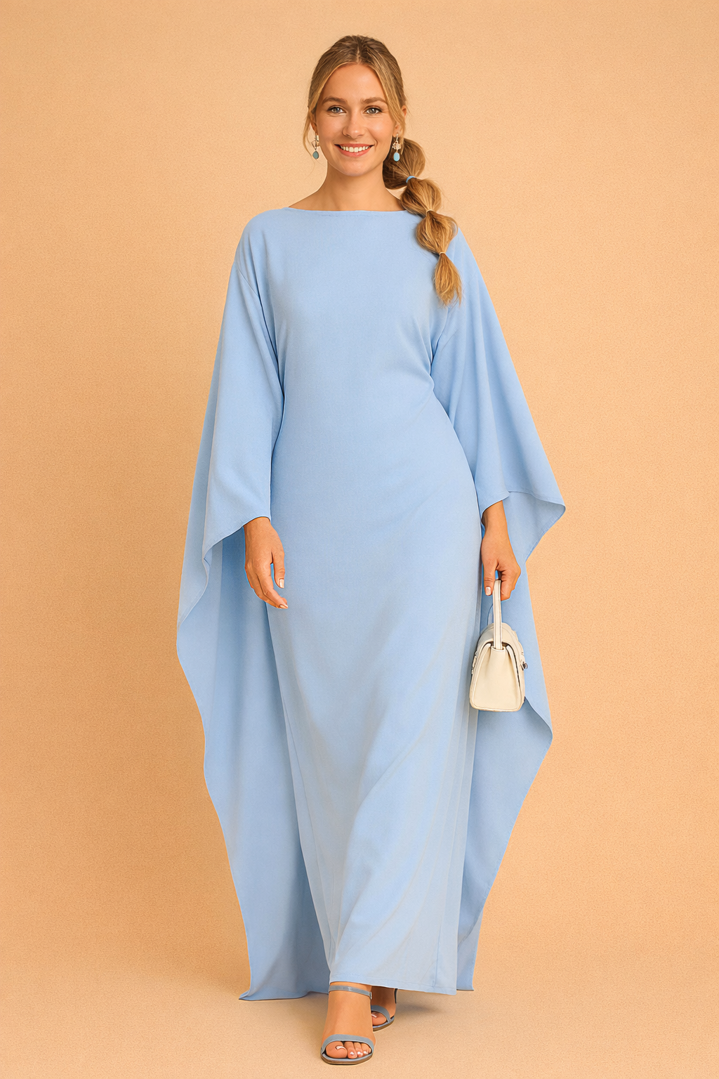 Chic evening dress featuring dramatic batwing sleeves and a floor-length hem.