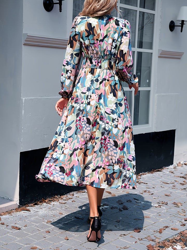 A beautiful wedding guest dress featuring a floral print and midi length.