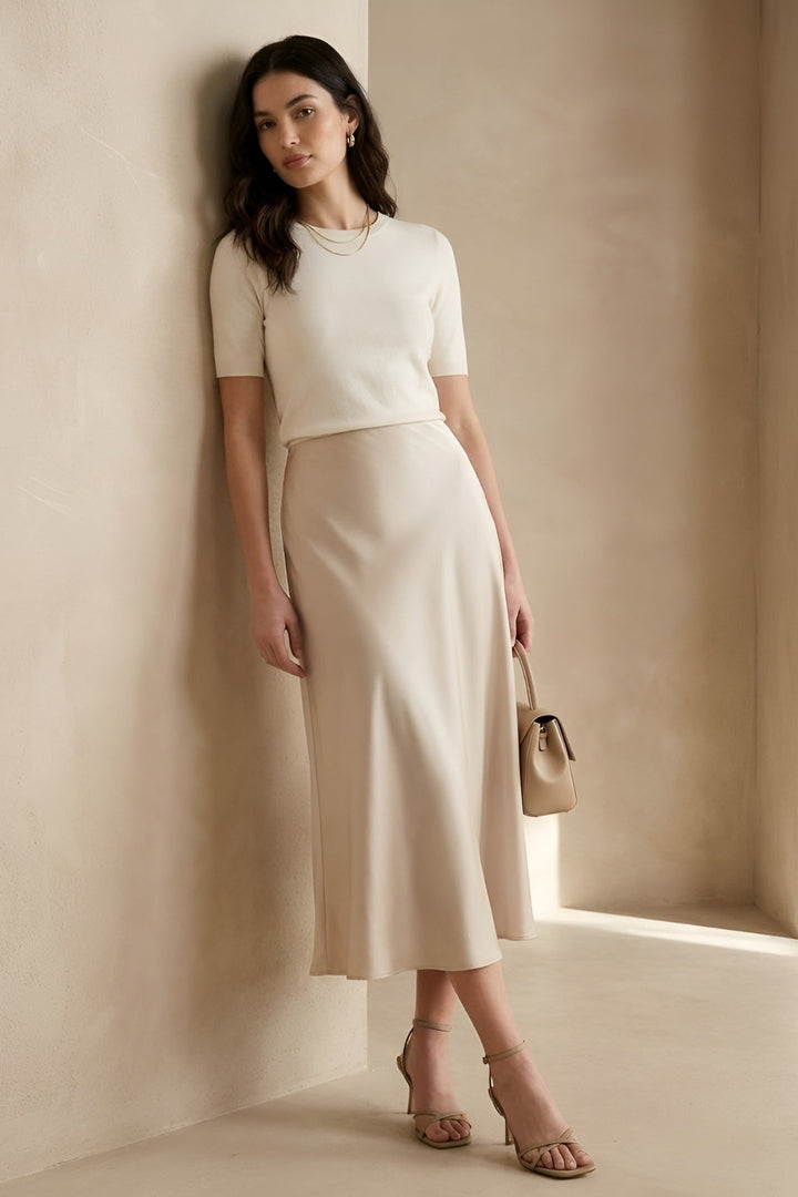 Elegant beige high-waisted A-line midi skirt for women, perfect for chic office wear or casual spring looks.