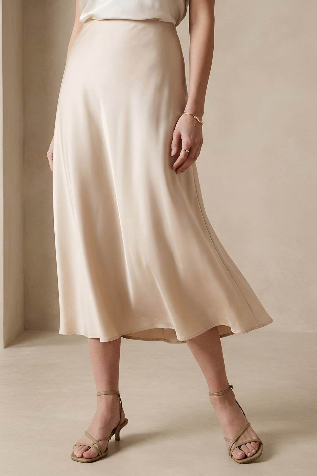Chic high-waisted beige midi skirt, A-line silhouette for a flattering and elegant women's fashion style.