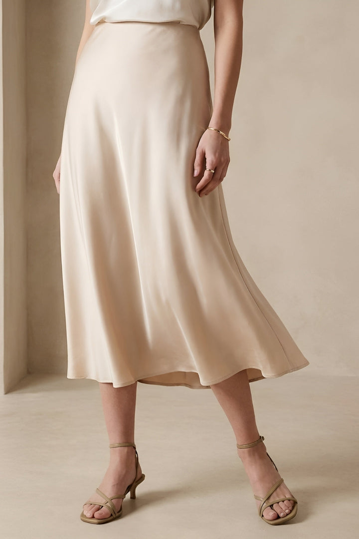Chic high-waisted beige midi skirt, A-line silhouette for a flattering and elegant women's fashion style.