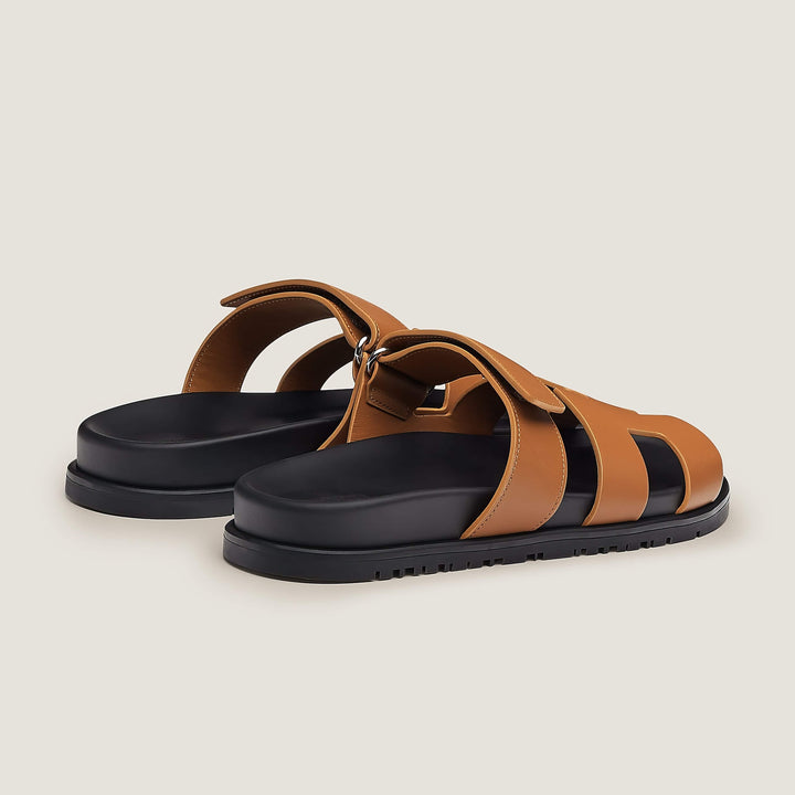 Close-up on the texture of soft leather used in these chic women's strappy sandals.