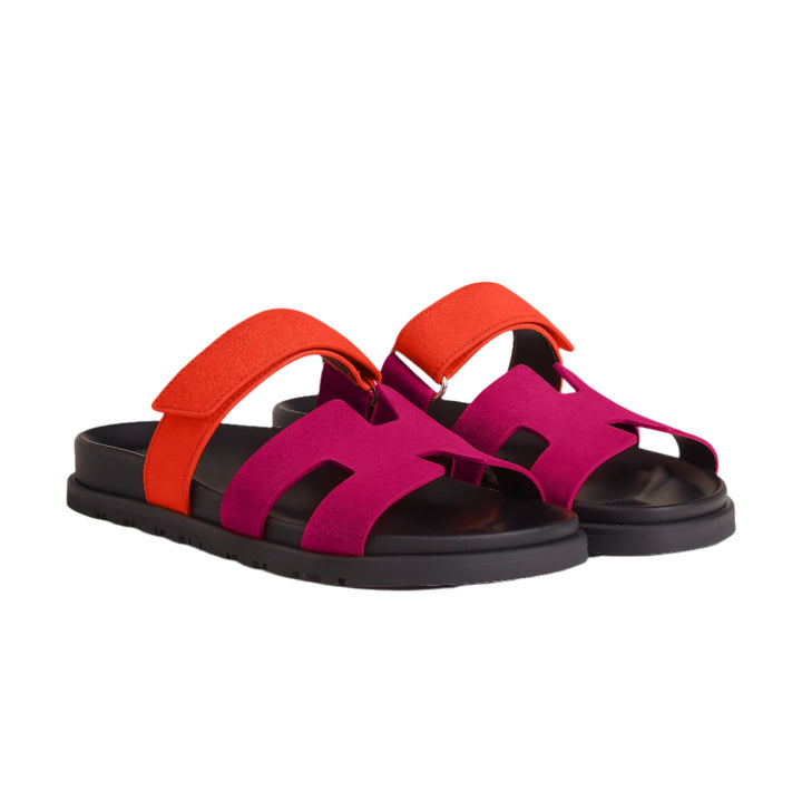 Woman's feet wearing comfortable all-black leather strappy sandals for a stylish look.