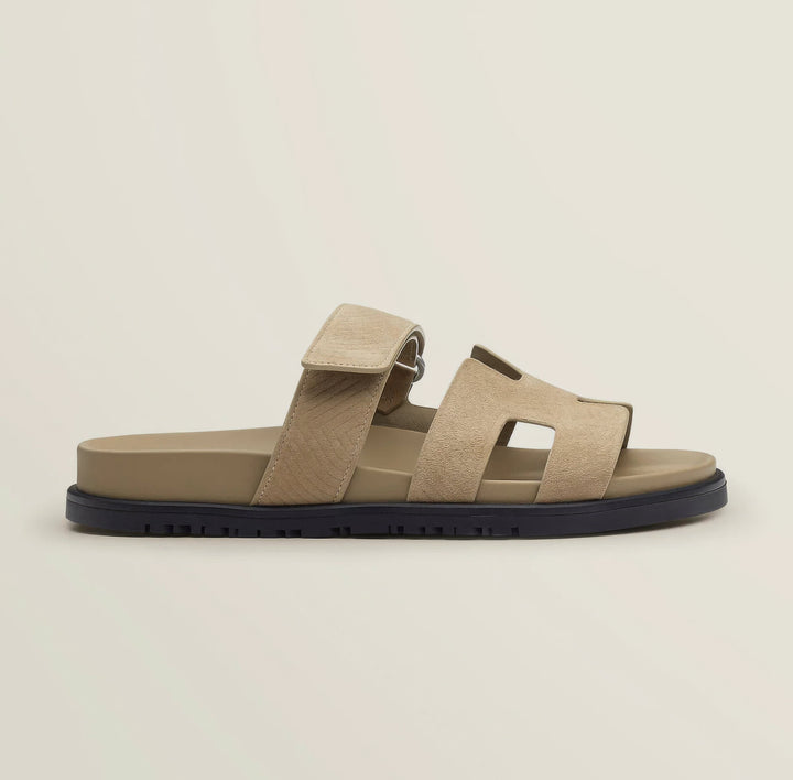 Detail shot of the buckle on an adjustable strap of elegant leather summer sandals.