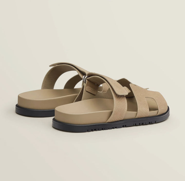 Pair of chic women's leather sandals in a tan color, highlighting comfort and style.
