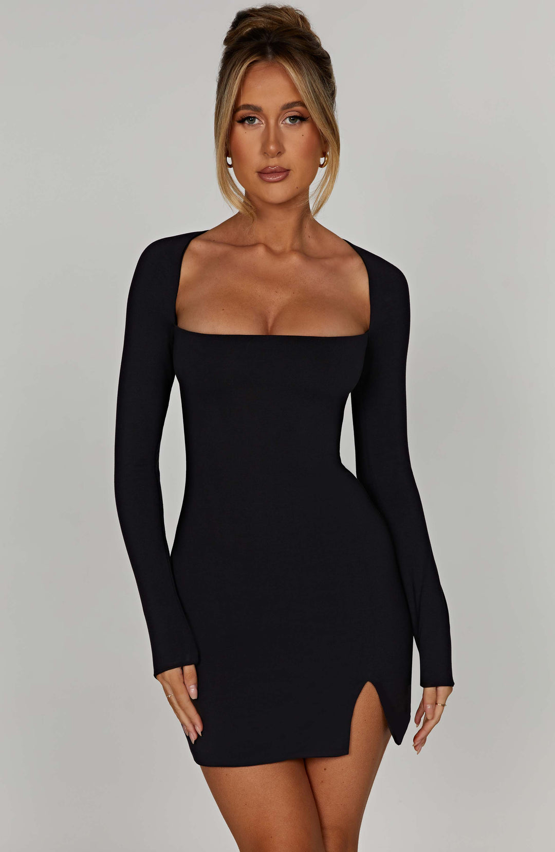 Elegant black mini dress for women, featuring a chic square neckline and long sleeves. Perfect for evening wear.