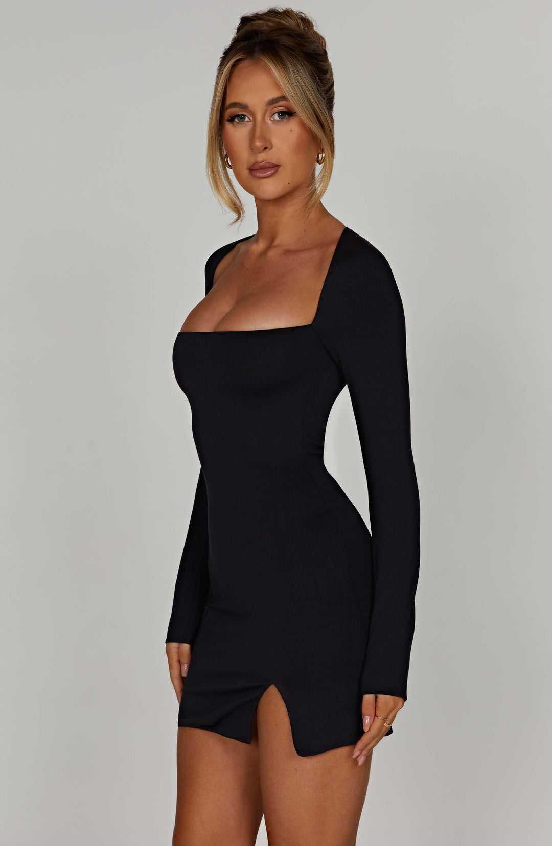 Women's elegant black long-sleeve mini dress, designed with a sophisticated square neckline for any occasion.