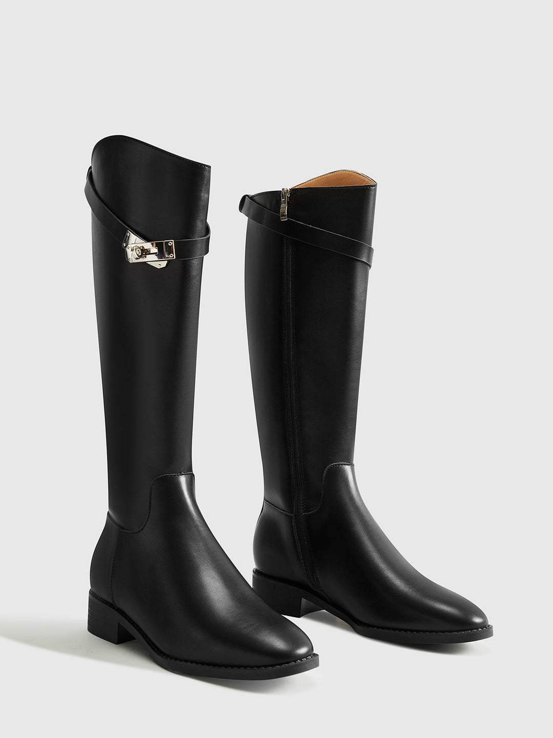 Full view of chic black knee-high riding boots, perfect elegant fashion footwear for women's fall/winter.