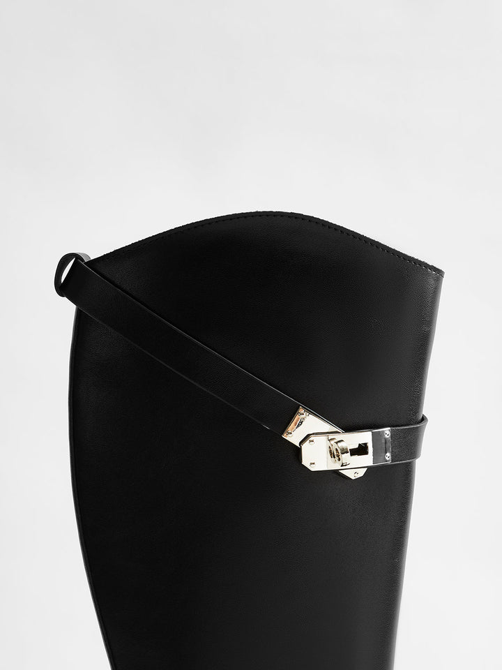 Stylish black knee-high riding boots for women. Elegant tall boots, ideal for sophisticated fall & winter looks.