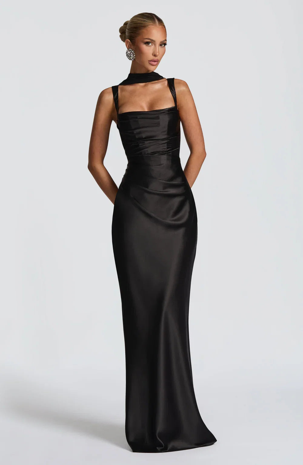 Women's elegant black maxi dress featuring a flattering ruched waist & adjustable spaghetti straps for summer.
