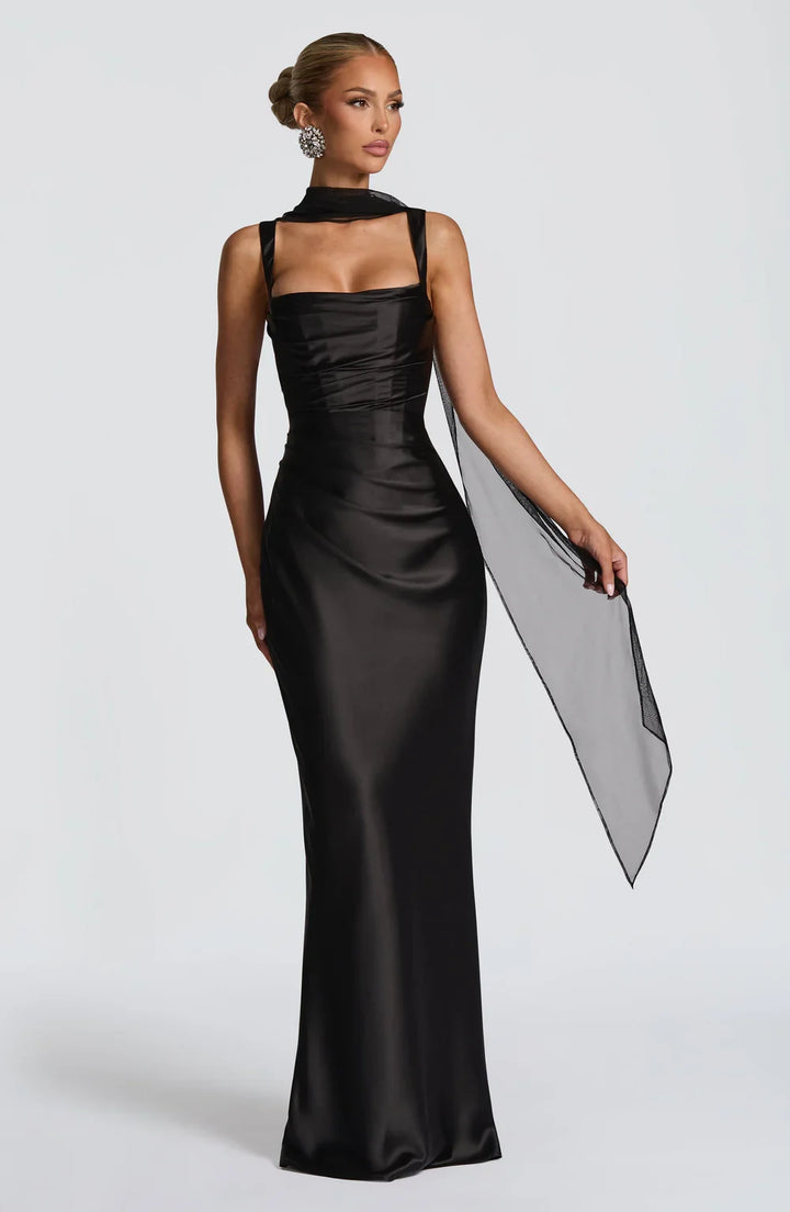Flowy black women's summer maxi dress with a flattering ruched waist and adjustable straps for elegance.
