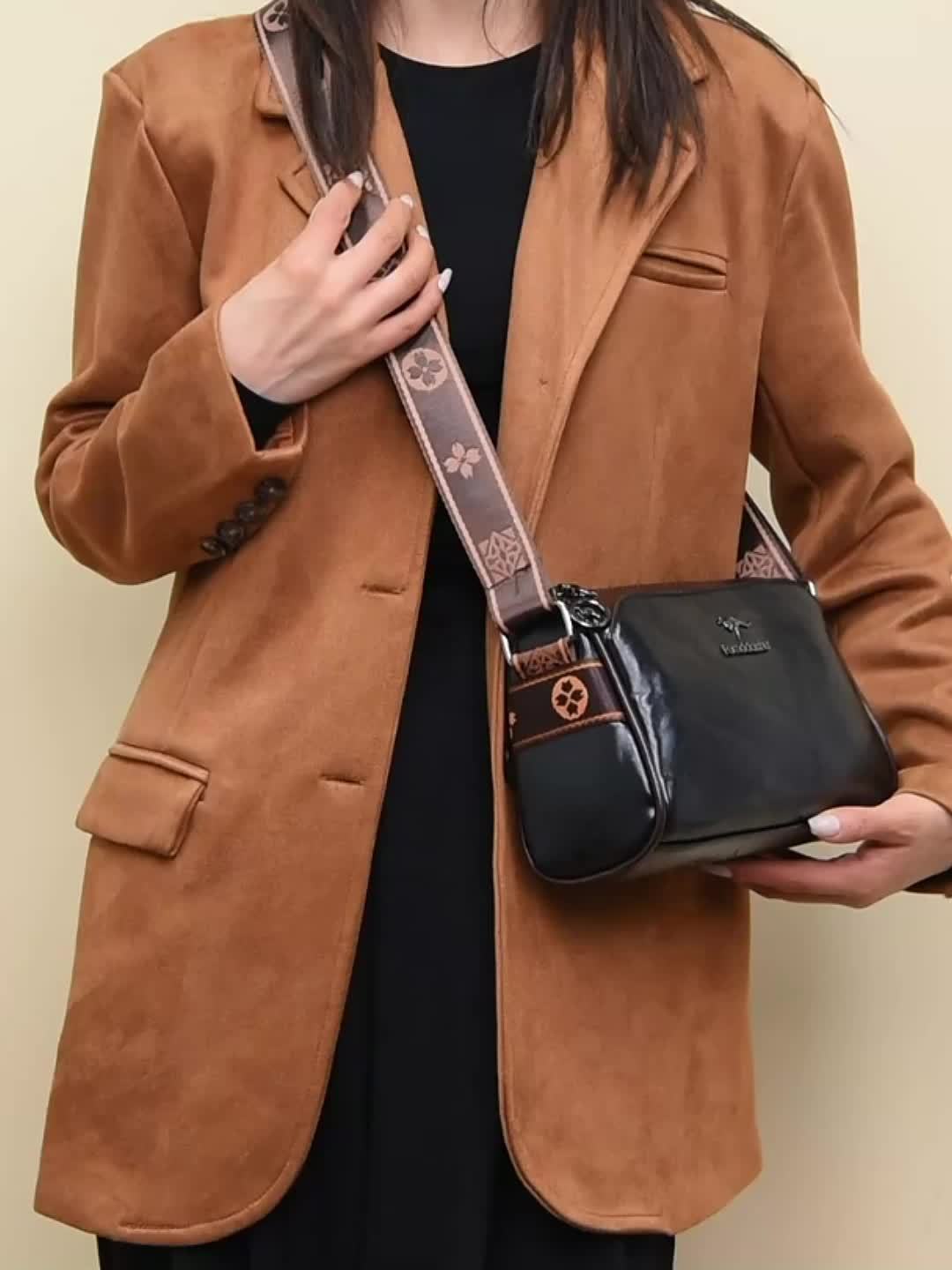 Stylish brown shoulder bag for women. Features an organized interior & adjustable strap for everyday elegance.