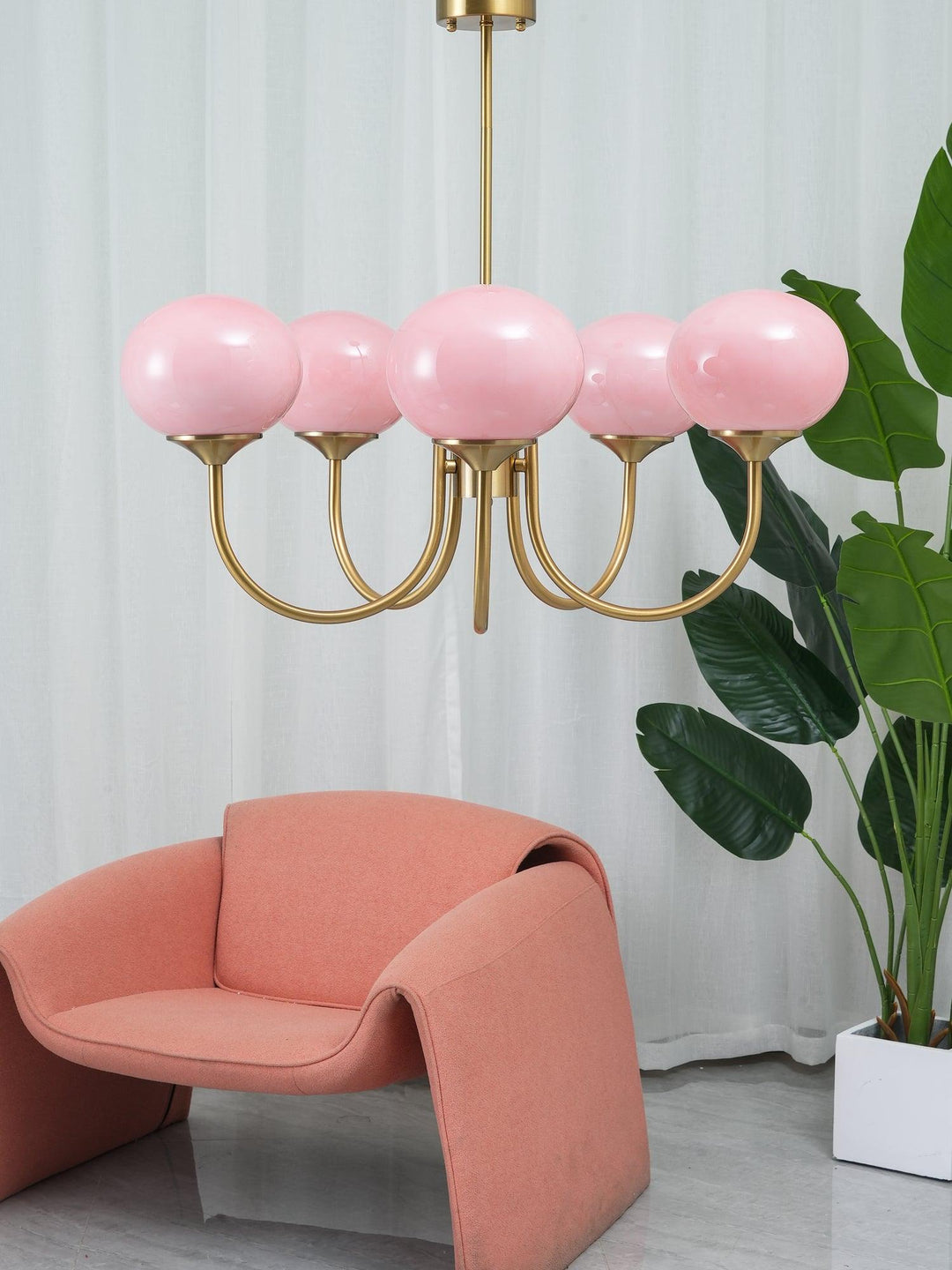 Striking brass circle pendant with multiple glass spheres, ideal for contemporary homes.