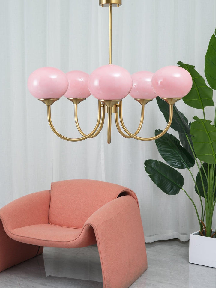 Striking brass circle pendant with multiple glass spheres, ideal for contemporary homes.