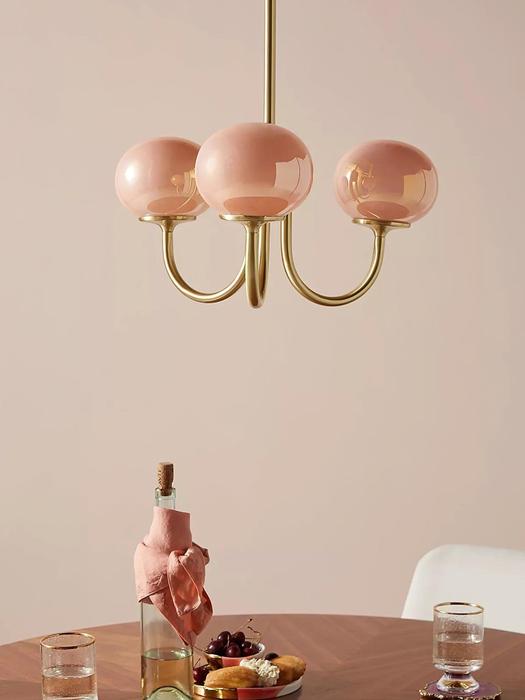 Stylish brass pendant, circular design with opal glass shades for elegant dining.