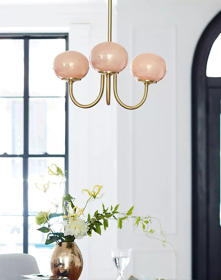 Contemporary gold-finish circular overhead fixture for ambient light in dining rooms.