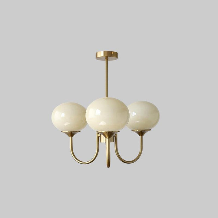 Sophisticated brass ring pendant with opal glass shades for elegant dining rooms.