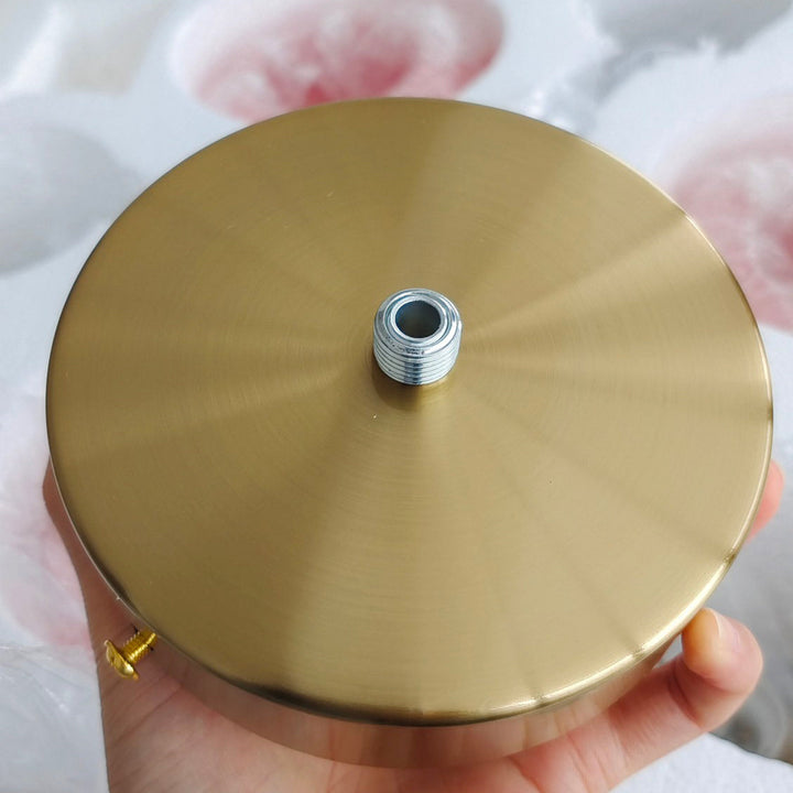 Striking gold-finish circular pendant, a decorative ambient light for interiors.