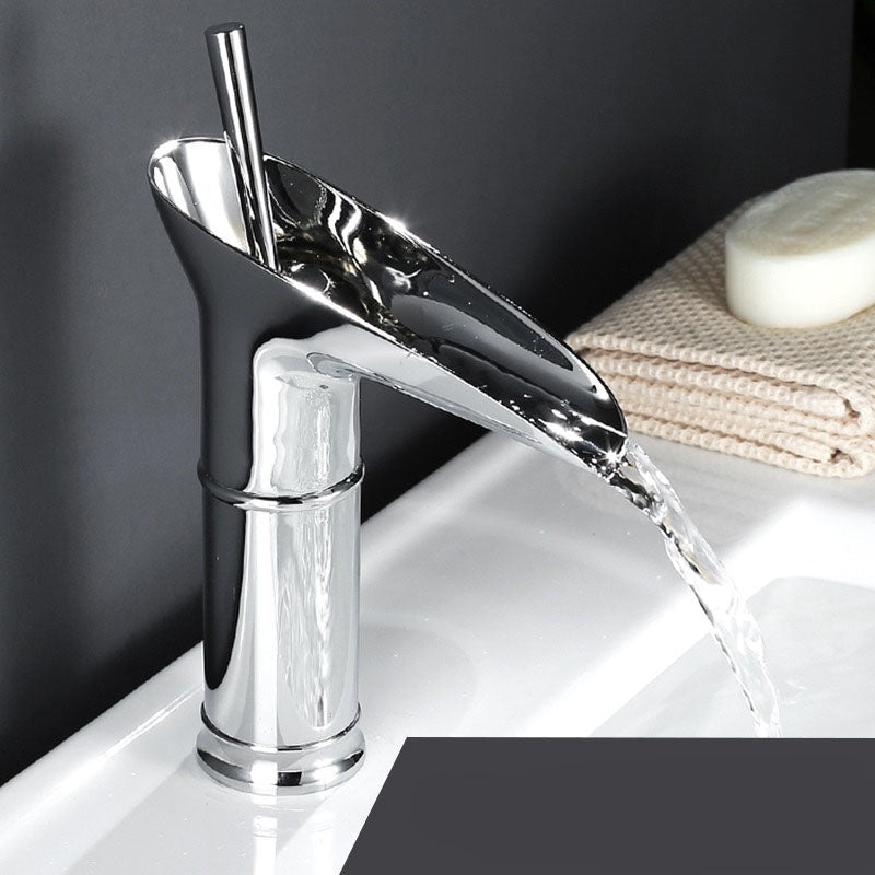 Luxury waterfall basin tap, polished brass mixer for elegant bathrooms.