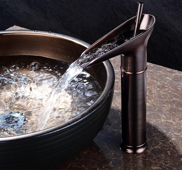Brass waterfall basin faucet, elegant mixer tap for contemporary bathrooms.