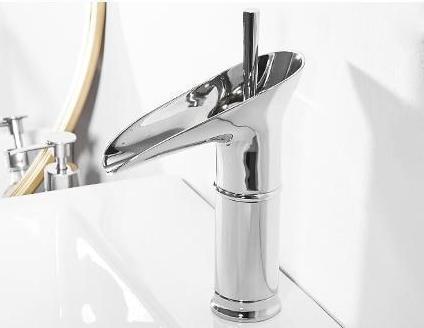 Deck-mounted waterfall sink mixer in polished brass, modern design.